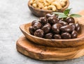 Sweet cashew and chocolate covered nuts on gray stone background