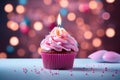 Sweet celebration Cupcake with pink cream and burning candle