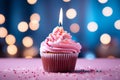 Sweet celebration Cupcake with pink cream and burning candle