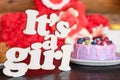 Sweet cheese cake with fresh berries and yoghurt cream and wooden sign Its A Girl. Baby shower party sweets. Royalty Free Stock Photo