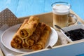 Sweet cheese stuffed pancakes and cup of coffee.