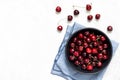 Sweet cherries in bowl over bright background, table top view Royalty Free Stock Photo