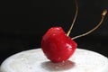 Wet cherries on a black background. Royalty Free Stock Photo