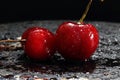 Wet cherries on a black background. Royalty Free Stock Photo