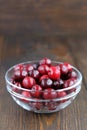 Sweet cherries in glass bowl on wooden table. Royalty Free Stock Photo