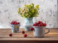 Sweet cherries in a large mug and a decorative bucket, a bouquet of wild flowers in a blue vase