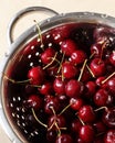 Sweet cherries in metal colander with water drops. Washed garden juicy berries. Life photo, natural concept. Summer harvest. Hard Royalty Free Stock Photo