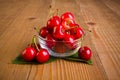 Sweet cherries (Prunus avium) in plate on wooden board