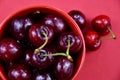 Sweet cherries in a red bowl top view stock images Royalty Free Stock Photo