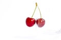 Sweet cherries. Red cherries hang on a transparent glass. A ripe berry on a white background.