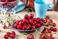 Sweet cherries with water drops in a dark plate