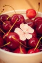 Sweet cherry berries in a white plate on a wooden background. Ripe red berries Royalty Free Stock Photo