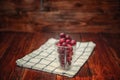 Sweet cherry black cherries in a glass on wooden background Royalty Free Stock Photo