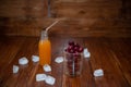 Sweet cherry, black cherries in a glass on wooden background with fresh juicy in glass bottle Royalty Free Stock Photo