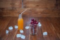 Sweet cherry, black cherries in a glass on wooden background with fresh juicy in glass bottle Royalty Free Stock Photo