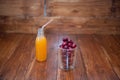 Sweet cherry, black cherries in a glass on wooden background with fresh juicy in glass bottle Royalty Free Stock Photo