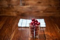 Sweet cherry, black cherries in a glass on wooden background Royalty Free Stock Photo