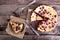 Sweet cherry clafouti on old wooden rustic background.