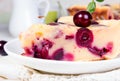 Sweet cherry clafouti. Piece of cake on wihite saucer