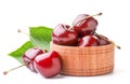 Sweet cherry with green leaves in a wooden plate on a white background. Isolated Royalty Free Stock Photo