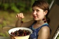 Sweet cherry merry in human hand with teenager girl on background