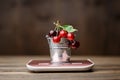 Sweet cherry in small decorative metal bucket standing on a cooking scale Royalty Free Stock Photo