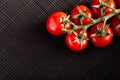 Sweet cherry tomato on black asian background