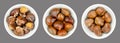 Chestnuts, unshelled, roasted and boiled marrons, in white bowls over gray Royalty Free Stock Photo