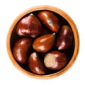 Sweet chestnuts in wooden bowl on white background