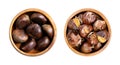 Sweet chestnuts, raw and freshly roasted, in wooden bowls Royalty Free Stock Photo