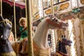 Sweet child, cute blond boy, riding on a merry-go-round, carousel attraction in Europe Royalty Free Stock Photo