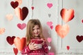 Sweet child girl with red heart box. Happy little girl with Valentine`s gift. Wedding, Valentine concept.