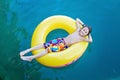 Sweet child, preschool boy. lying on floating ring in lake