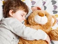 Sweet child sleeping with teddy bear