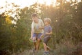 Sweet children, boys, playing in the park on sunset, autumn