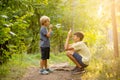 Sweet children, boys, playing in the park on sunset, autumn