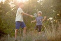 Sweet children, boys, playing in the park on sunset, autumn