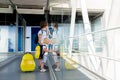 Sweet children, brothers, boys, walking hand in hand at the airport, carrying suitcases and backpacks