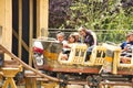 Sweet children, riding in a train on a merry-go-round, carousel attraction in Europe, active children, summertime Royalty Free Stock Photo