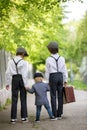 Sweet children in vintage clothing, hat, suspenders and white shirts, holding suitcase, running in the park Royalty Free Stock Photo