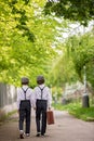 Sweet children in vintage clothing, hat, suspenders and white shirts, holding suitcase, running in the park Royalty Free Stock Photo