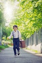 Sweet children in vintage clothing, holding suitcase, running in the park Royalty Free Stock Photo