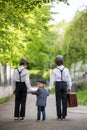 Sweet children in vintage clothing, holding suitcase, running in the park Royalty Free Stock Photo