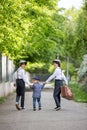 Sweet children in vintage clothing, holding suitcase, running in the park Royalty Free Stock Photo