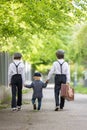 Sweet children in vintage clothing, holding suitcase, running in the park Royalty Free Stock Photo