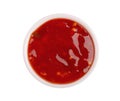 Sweet chili pepper sauce in bowl, isolated on white background. Spicy tomato and chili pepper sauce. Top view