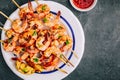 Sweet Chili Shrimp Skewers with lemon and parsley on gray stone background Royalty Free Stock Photo