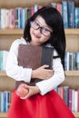 Sweet chinese schoolgirl in the library Royalty Free Stock Photo