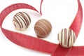 Sweet chocolate balls with red heart robbon Royalty Free Stock Photo