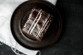 Sweet chocolate brownie with coffe cream on a dark, rustic, wooden table Royalty Free Stock Photo